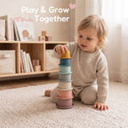 The Discoverer Growing Play Box - baby stacking the colorful cups