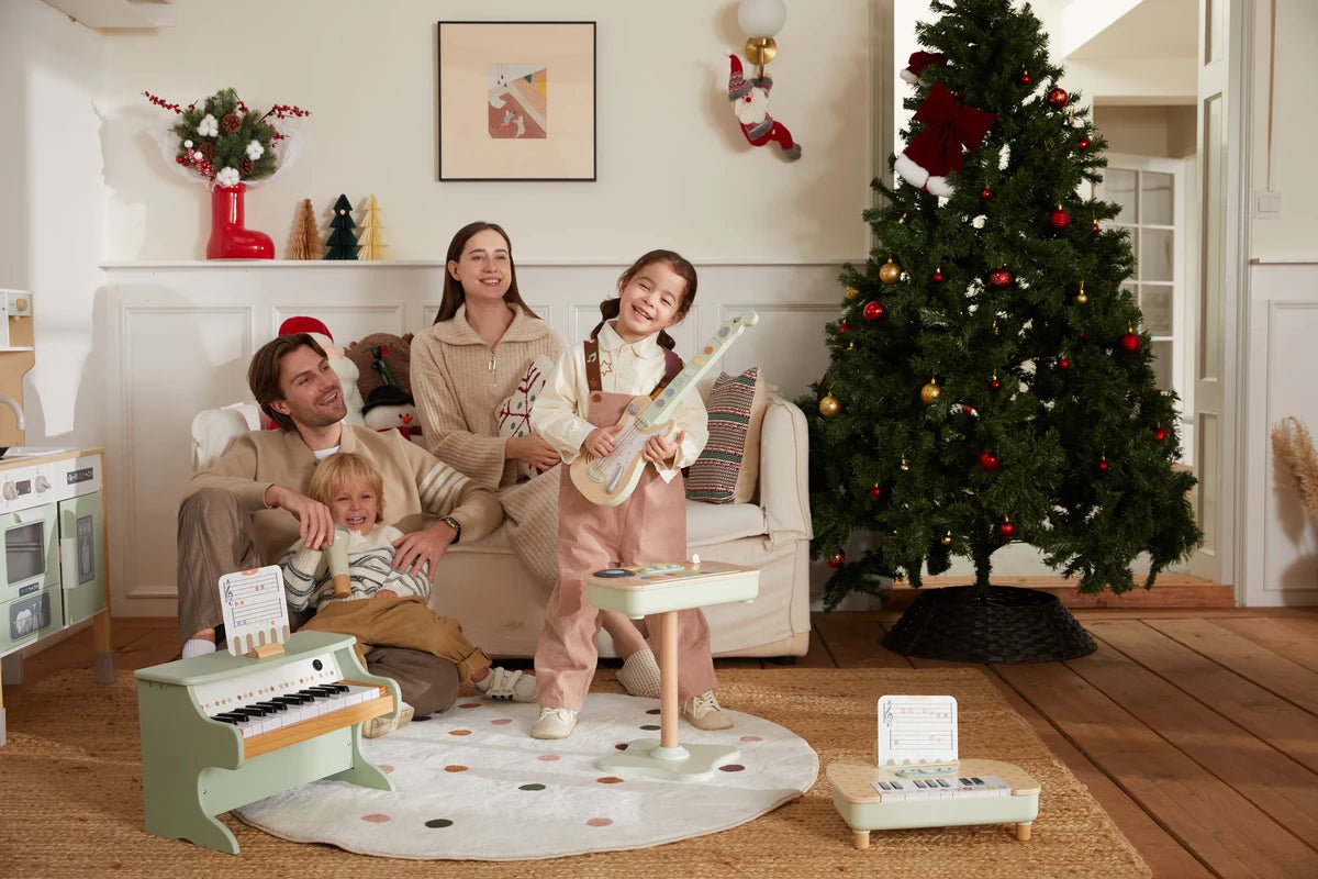 Family with kids using wooden educational toys near Christmas tree in living room.