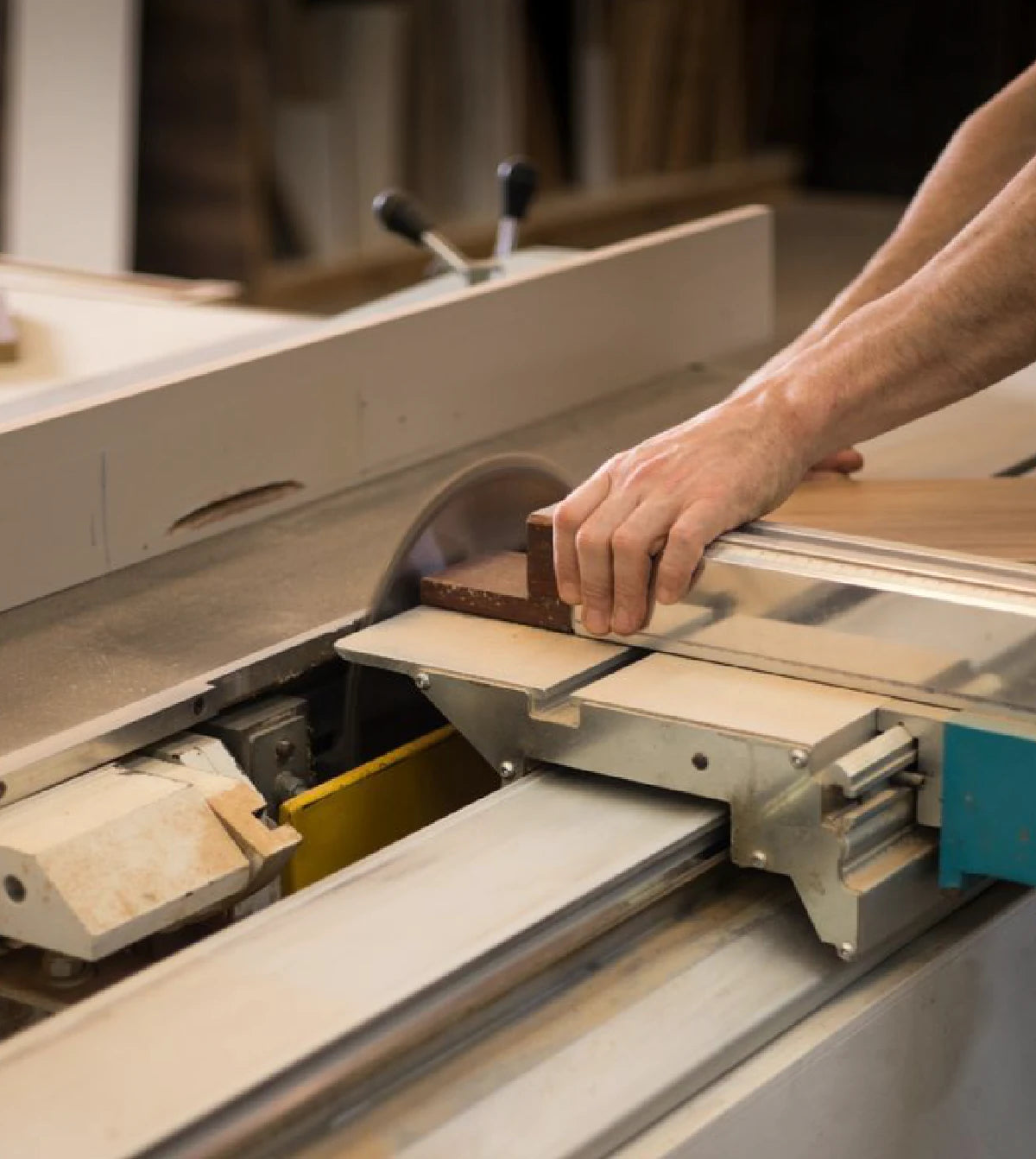 Person cutting wood with a table saw.