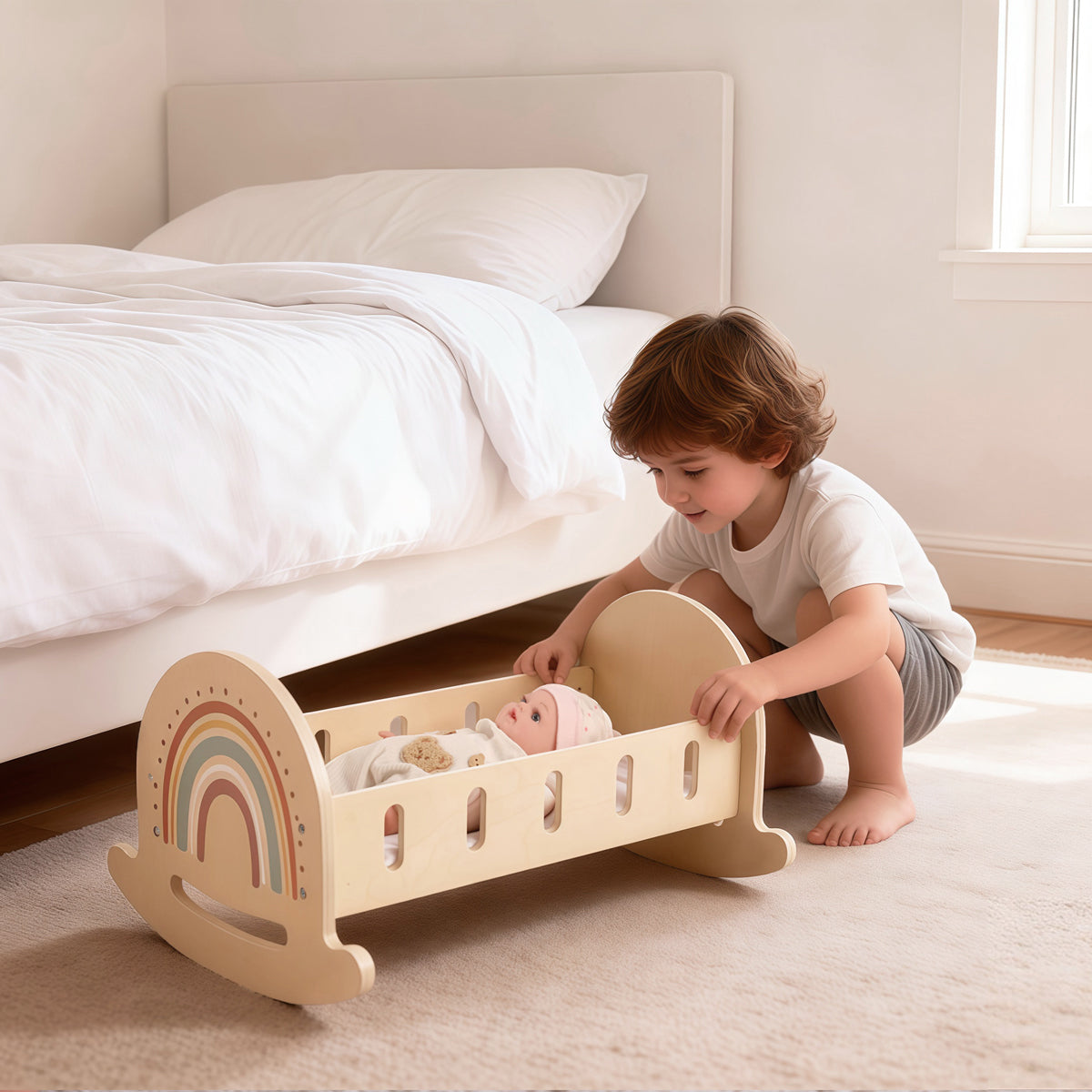Young boy playing with a wooden doll cradle and baby doll