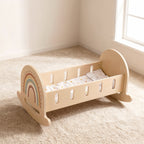 Wooden rocking doll cradle with rainbow design and star bedding