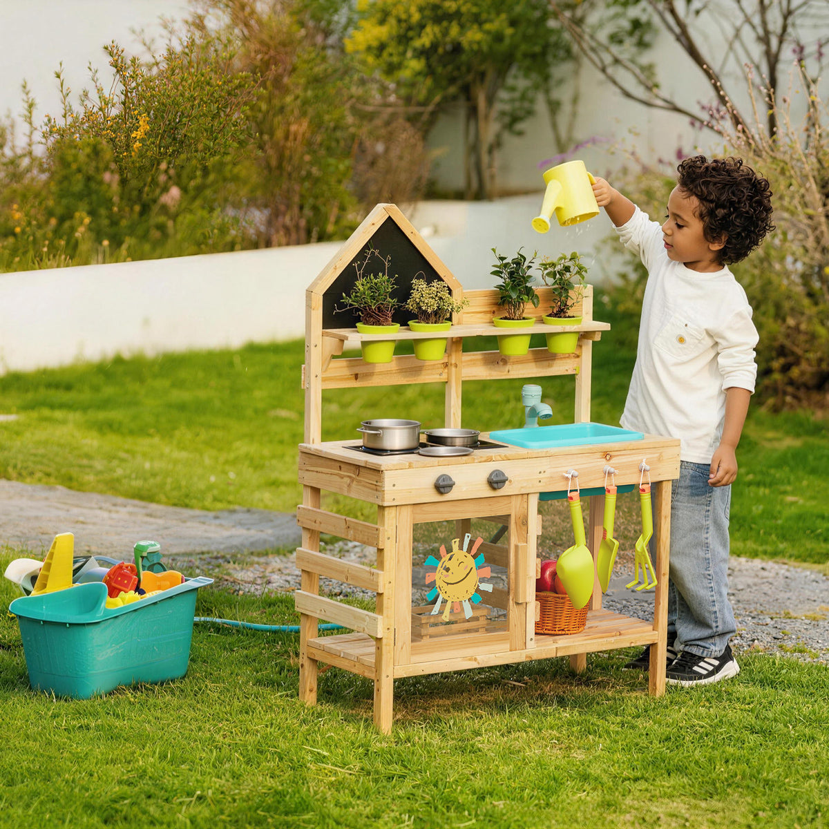 Wooden outdoor play kitchen with child watering plants from yellow can.