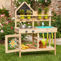 Wooden kids play kitchen with chalkboard, plants, sink, and food.
