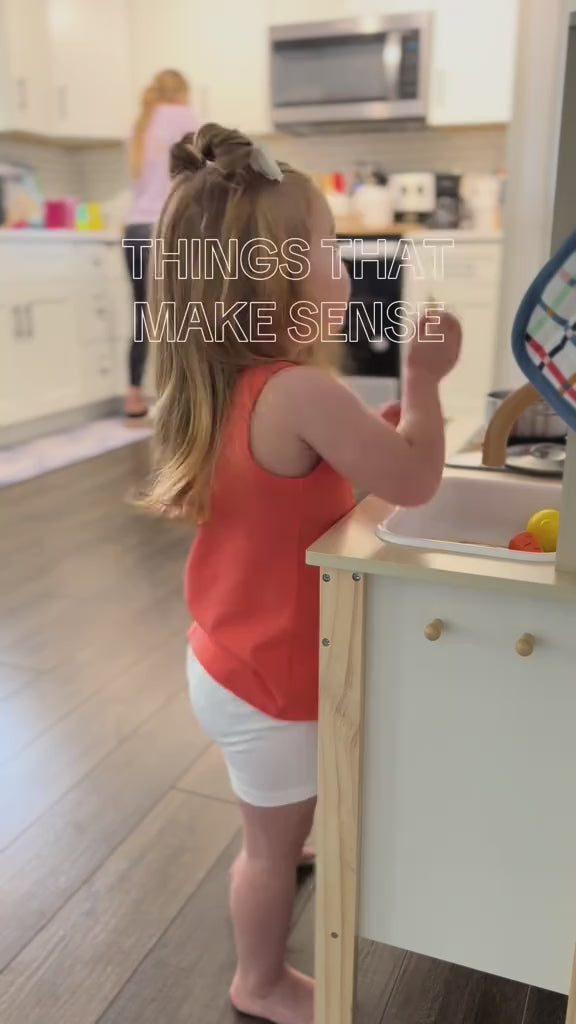 Toddler using wooden kitchen set to cook with you.; Hand holding a wooden toy, labeled "functional".