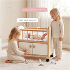 Wooden doll crib two girls tucking baby lifestyle