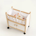 Wooden doll crib with doll inside top angle