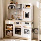 White wooden kids play kitchen with microwave, oven, sink, and storage baskets.