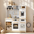 White wooden play kitchen with coffee, microwave, oven, and toy food items.